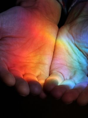 rainbow light in cupped hands