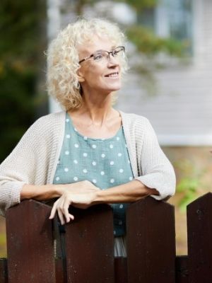 woman by her picket fence