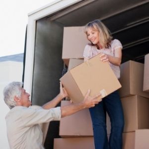 couple moving boxes into truck